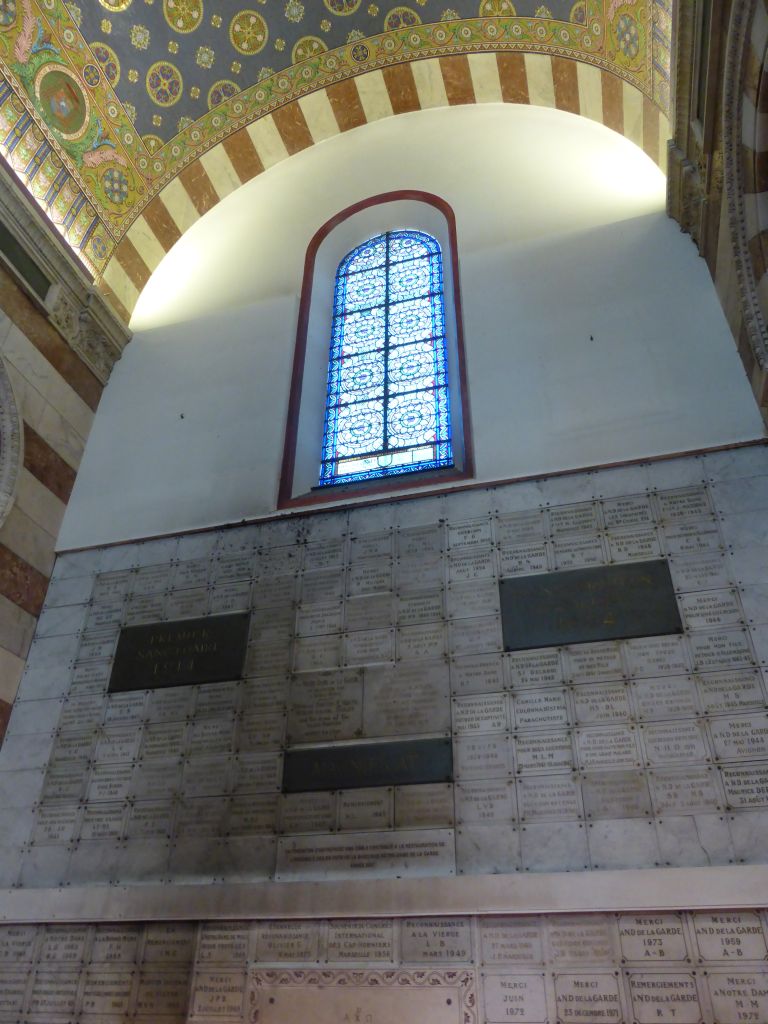 Tiles and stained glass window at the first left side chapel of the Notre-Dame de la Garde basilica