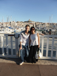 Tim and Miaomiao at the Quai du Port street with a view on the boats in the Old Port and the Notre-Dame de la Garde basilica