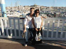 Tim and Miaomiao at the Quai du Port street with a view on the boats in the Old Port and the Notre-Dame de la Garde basilica