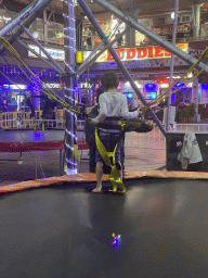 Max being prepared at the bungee trampoline at the Yumbo Centrum shopping mall, by night