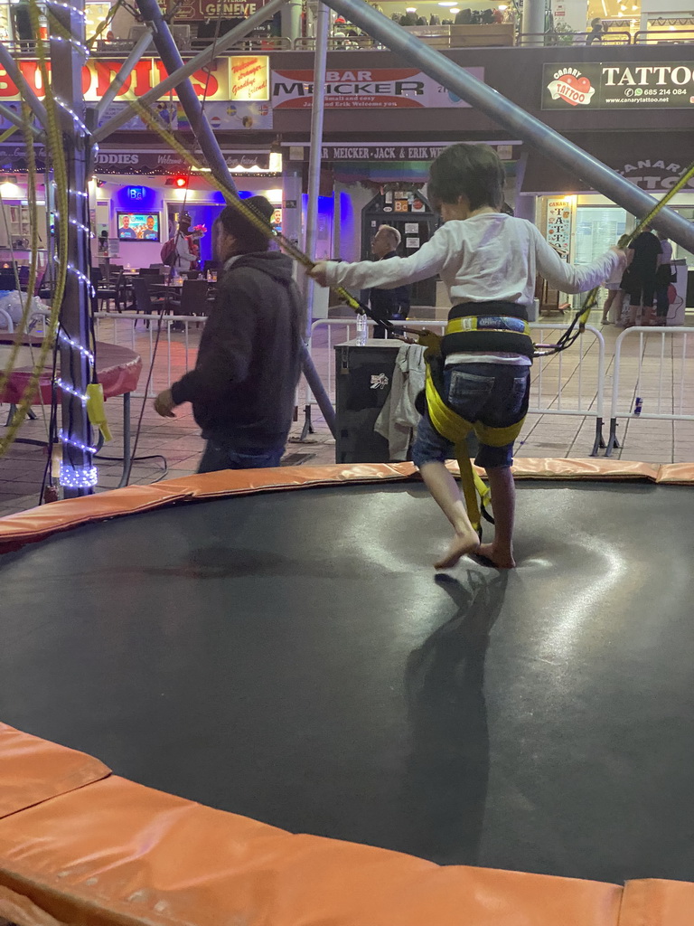 Max at the bungee trampoline at the Yumbo Centrum shopping mall, by night