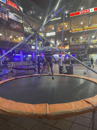 Max jumping at the bungee trampoline at the Yumbo Centrum shopping mall, by night