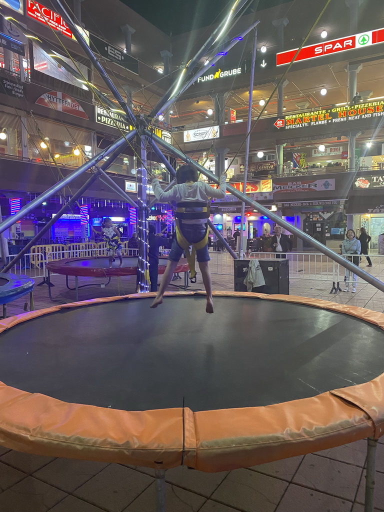 Max jumping at the bungee trampoline at the Yumbo Centrum shopping mall, by night
