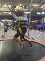 Max jumping at the bungee trampoline at the Yumbo Centrum shopping mall, by night