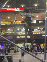 Max jumping at the bungee trampoline at the Yumbo Centrum shopping mall, by night