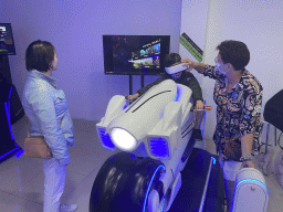 Miaomiao and Max doing a virtual reality motor cycle game at the VR Arena at the Yumbo Centrum shopping mall