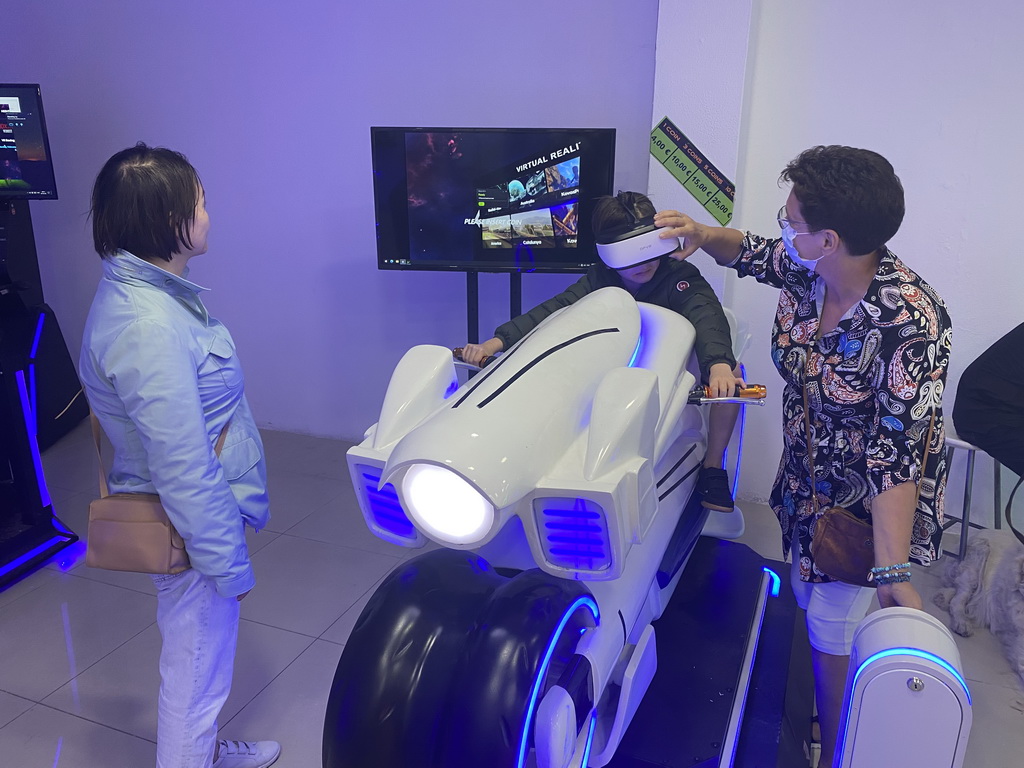 Miaomiao and Max doing a virtual reality motor cycle game at the VR Arena at the Yumbo Centrum shopping mall