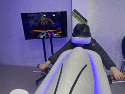 Max doing a virtual reality motor cycle game at the VR Arena at the Yumbo Centrum shopping mall