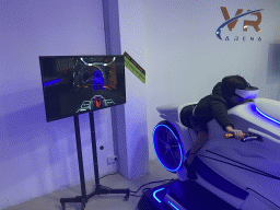 Max doing a virtual reality motor cycle game at the VR Arena at the Yumbo Centrum shopping mall
