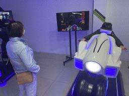 Miaomiao and Max doing a virtual reality motor cycle game at the VR Arena at the Yumbo Centrum shopping mall