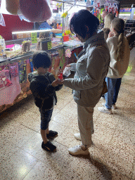 Miaomiao and Max with candy at the Yumbo Centrum shopping mall, by night