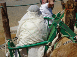 Miaomiao on her Dromedary at the starting point of the Camel Safari, viewed from Tim`s Dromedary