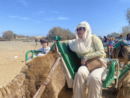 Miaomiao and Max on their Dromedary at the ending point of the Camel Safari, viewed from Tim`s Dromedary