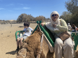Miaomiao and Max on their Dromedary at the ending point of the Camel Safari, viewed from Tim`s Dromedary