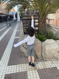 Max with a sign of the Max & Mirelle massage salon at the pedestrian street inbetween the Jardin del Sol hotel and the Hotel Riu Papayas