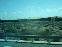 Greenhouses and windmills near the Cañada de la Cebolleta ravine, viewed from the bus to Las Palmas at the GC-1 road