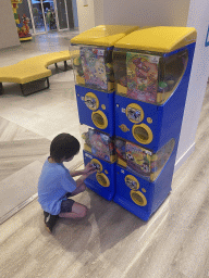 Max getting a ball with a toy from a machine at the gaming room at the Abora Buenaventura by Lopesan hotel