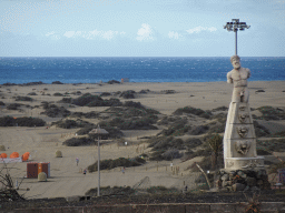 Statue and the Maspalomas Dunes, viewed from the Paseo Costa Canaria street