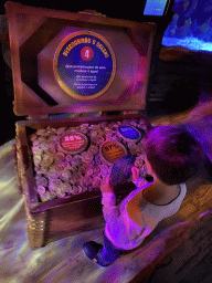Max doing the scavenger hunt at a treasure chest at the Sea Life Porto
