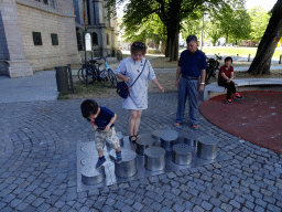 Miaomiao, Max and Miaomiao`s parents on a playground on the Sint-Romboutskerkhof square