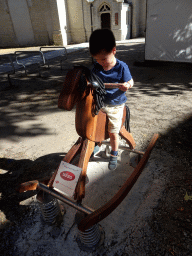 Max on a rocking horse at the Sint-Janstraat street