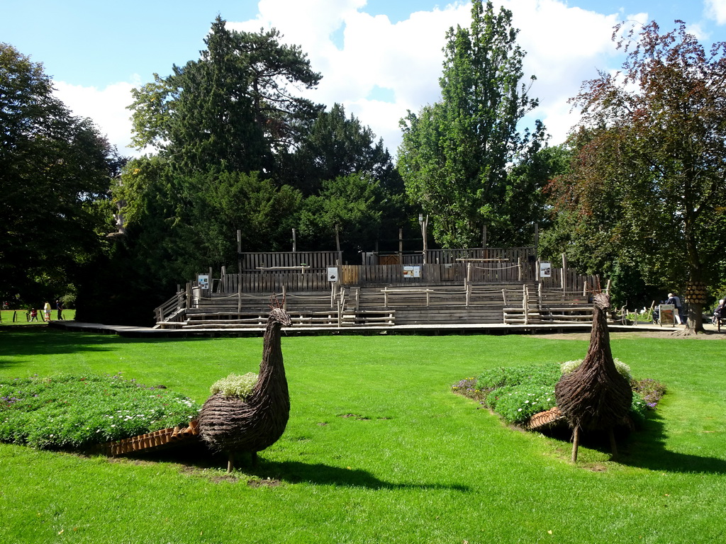 Peacock statues and the grandstand of the birds of prey show at the Europe section of ZOO Planckendael