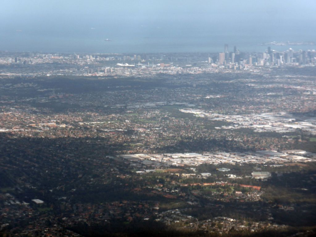 The suburb of Darebin, the AAMI Park stadium, skyscrapers in the city center and the coastline, viewed from the airplane from Sydney