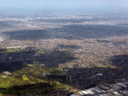 The north side of the city with the Bundoora Park Public Golf Course, skyscrapers in the city center and the coastline, viewed from the airplane from Sydney