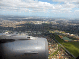 The north side of the city with the Hume Freeway and the Metropolitan Ring Road, skyscrapers in the city center and the coastline, viewed from the airplane from Sydney