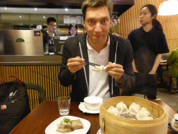 Tim eating dumplings at a Chinese restaurant at Little Bourke Street
