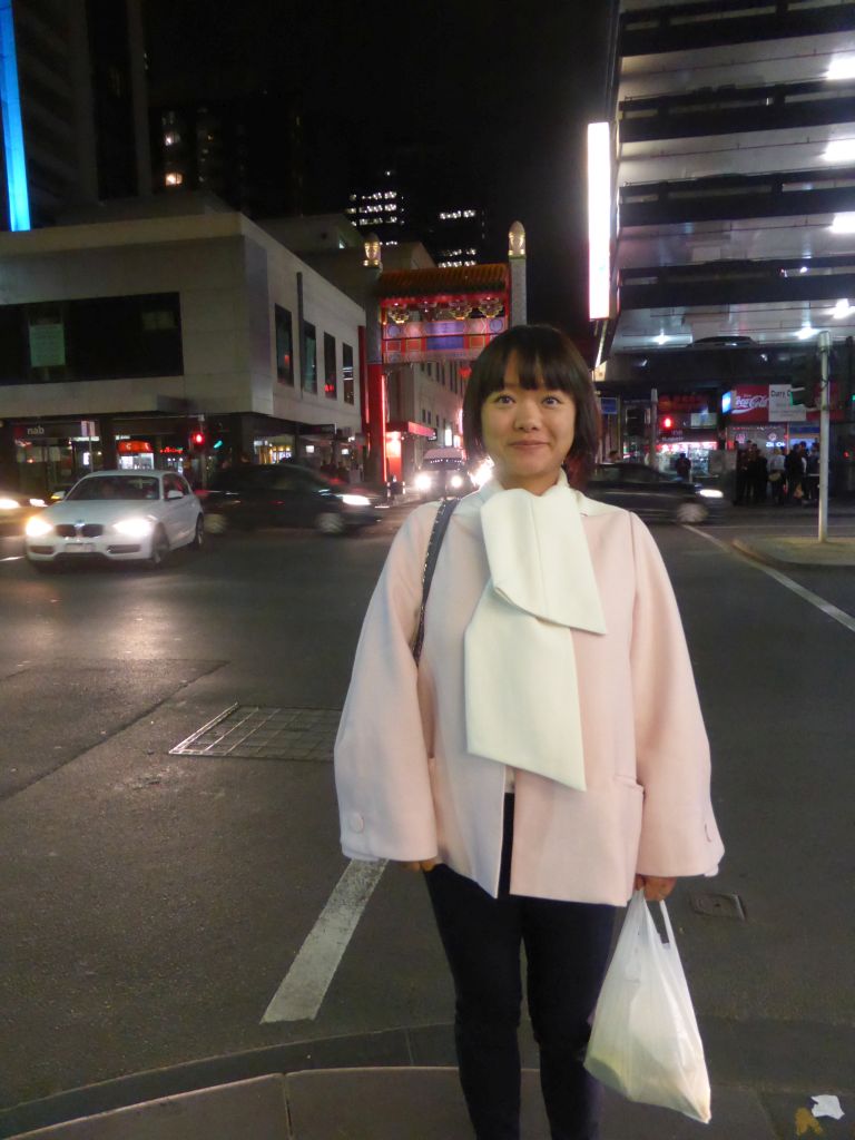 Miaomiao in front of the center east gate of Chinatown at the crossing of Little Bourke Street and Russell Street, by night