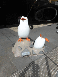 Statue of the penguins from the movie `Madagascar` in front of the Australian Centre for the Moving Image at Flinders Street
