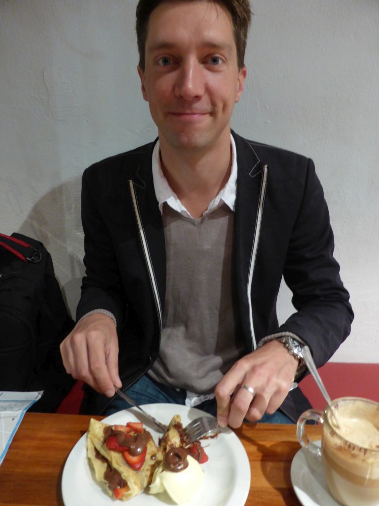 Tim having crêpe at the Aix Café at Centre Place