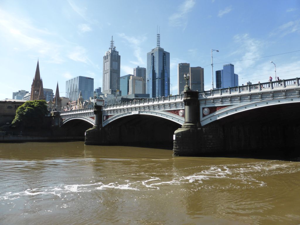 The Princess Bridge over the Yarra River, St. Paul`s Cathedral and skyscrapers in the city center, viewed from the Southbank Promenade