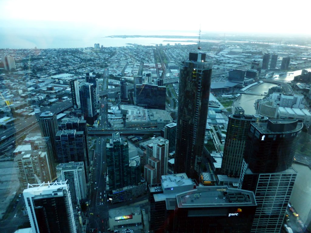 The southwest side of the city with the Freshwater Place building, the Prima Pearl Tower, the Crown Towers, the Melbourne Convention and Exhibition Centre, the Seafarers Bridge and the Charles Grimes Bridge over the Yarra River, the Port of Melbourne and Hobsons Bay, viewed from the Skydeck 88 of the Eureka Tower, at sunset