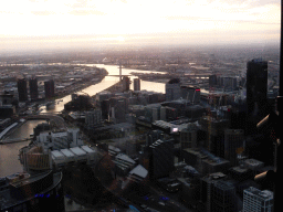 The west side of the city with the Rialto Towers, Batman`s Hill, Batman Park, and the Seafarers Bridge, the Charles Grimes Bridge, the Bolte Bridge and the West Gate Bridge over the Yarra River, viewed from the Skydeck 88 of the Eureka Tower, at sunset