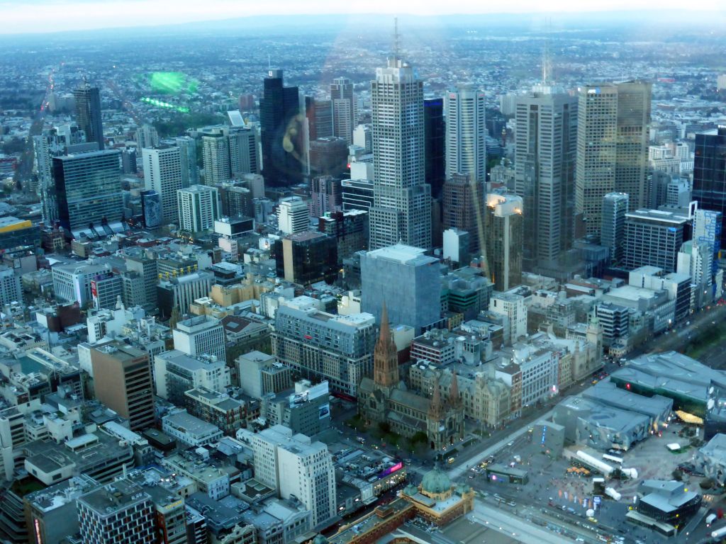 Skyscrapers at the city center, the Flinders Street Railway Station, St. Paul`s Cathedral and Federation Square with the Australian Centre for the Moving Image, viewed from the Skydeck 88 of the Eureka Tower, at sunset