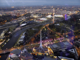The Spire of the Arts Centre Melbourne, the National Gallery of Victoria, the Queen Victoria Gardens, the Kings Domain, the Melbourne Cricket Ground, the Rod Laver Arena, Melbourne Park, the Hisense Arena, the AAMI Park, the Fitzroy Gardens and the Yarra River, viewed from the Skydeck 88 of the Eureka Tower, at sunset
