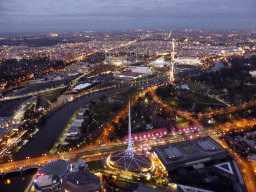 The Spire of the Arts Centre Melbourne, the National Gallery of Victoria, the Queen Victoria Gardens, the Kings Domain, the Melbourne Cricket Ground, the Rod Laver Arena, Melbourne Park, the Hisense Arena, the AAMI Park, the Fitzroy Gardens and the Yarra River, viewed from the Skydeck 88 of the Eureka Tower, at sunset