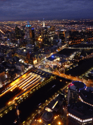 Skyscrapers at the city center, the Flinders Street Railway Station, St. Paul`s Cathedral, Federation Square with the Australian Centre for the Moving Image, the Southgate pedestrian bridge and the Princess Bridge over the Yarra River and the Fitzroy Gardens, viewed from the Skydeck 88 of the Eureka Tower, by night