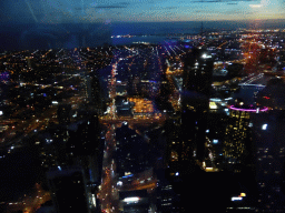 The southwest side of the city with the Prima Pearl Tower, the Port of Melbourne, the Seafarers Bridge over the Yarra River and Hobsons Bay, viewed from the Skydeck 88 of the Eureka Tower, by night