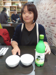 Miaomiao with a bottle of Soju at the Kim Chi Tray restaurant at Flinders Court