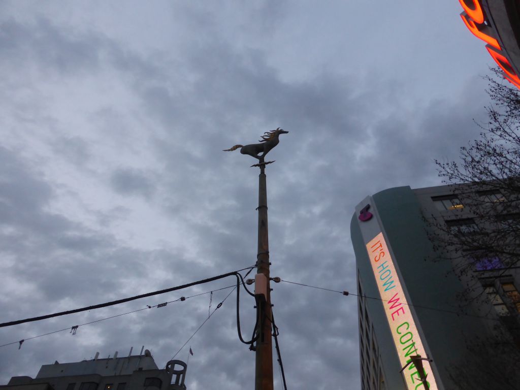 Statuette of a horse on top of a pole at the crossing of Bourke Street and Swanson Street, at sunset