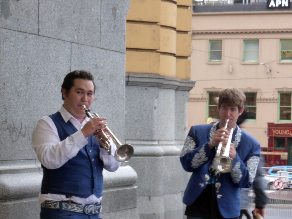 Street musicians in front of the Flinders Street Railway Station at the crossing of Flinders Street and St. Kilda Road