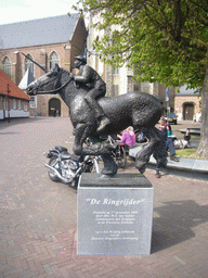 The statue `De Ringrijder` in front of the Abbey Tower and the Nieuwe Kerk church
