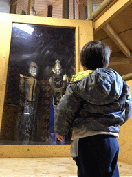 Max with two statues at the playground at the Indoor Apenkooien hall at the Dierenrijk zoo