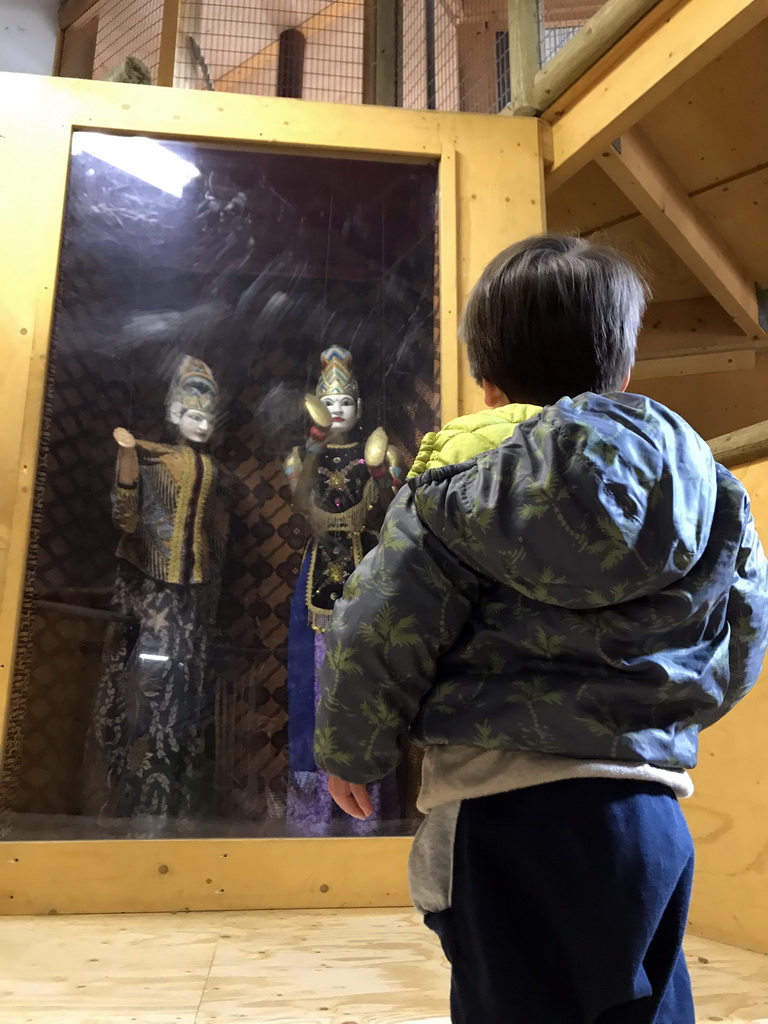 Max with two statues at the playground at the Indoor Apenkooien hall at the Dierenrijk zoo