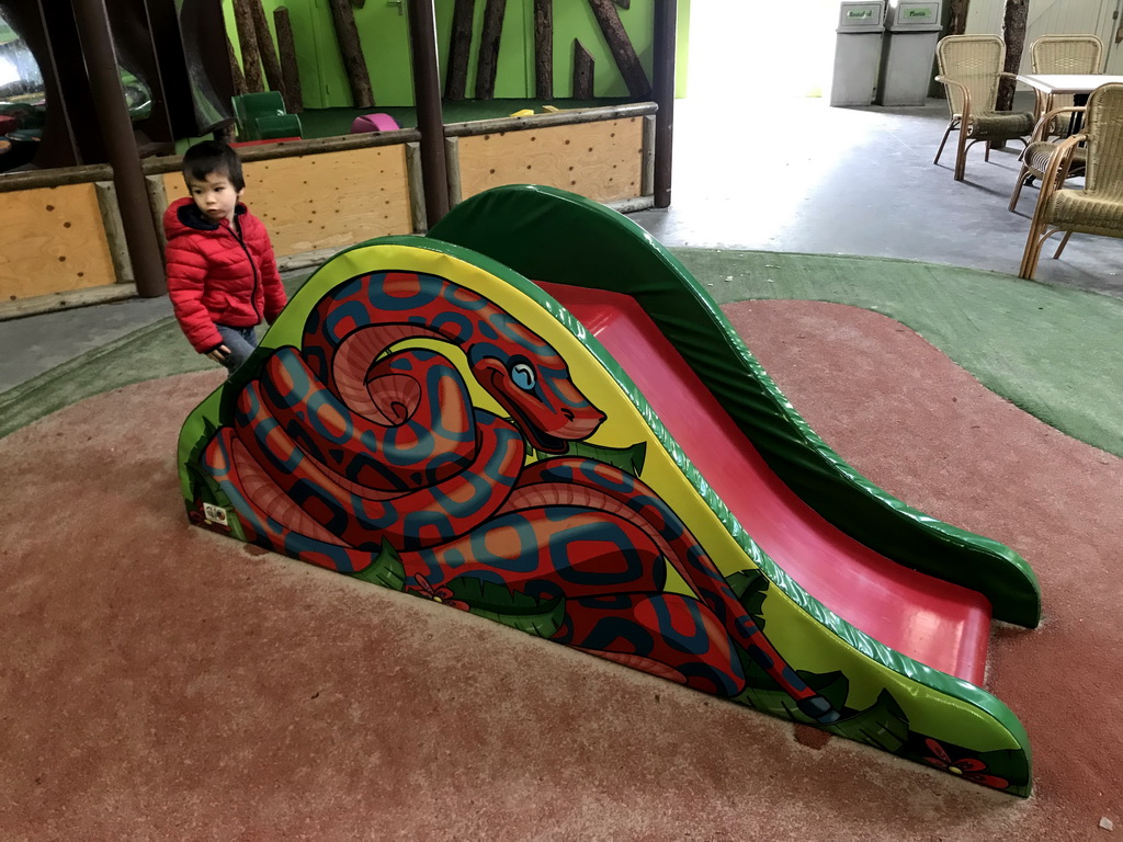 Max at a slide at the playground at the Indoor Apenkooien hall at the Dierenrijk zoo