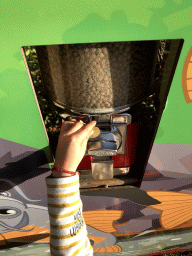 Max putting a coin in the fish food machine at the Dierenrijk zoo