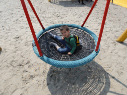 Max on a swing at the playground near Restaurant Smulrijk at the Dierenrijk zoo